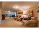Spacious basement with neutral carpet, couches, and decorative touches create a cozy living space at 428 W Valleyview Ave, Littleton, CO 80120
