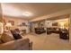 Spacious basement with cozy couches, carpeted floors, and a fireplace at 428 W Valleyview Ave, Littleton, CO 80120
