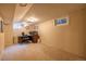 A home office in a carpeted basement with a window and a desk against the wall at 428 W Valleyview Ave, Littleton, CO 80120