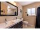 Bright bathroom with a double vanity, neutral tones, and modern fixtures at 428 W Valleyview Ave, Littleton, CO 80120