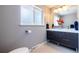 Contemporary bathroom with double sink vanity, modern fixtures, and a large window for natural light at 428 W Valleyview Ave, Littleton, CO 80120