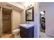 Bathroom features a modern vanity, a stylish mirror, and a walk-in shower with tiled walls at 428 W Valleyview Ave, Littleton, CO 80120
