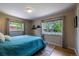 Bright bedroom with large windows, hardwood floors, and a cozy blue comforter at 428 W Valleyview Ave, Littleton, CO 80120