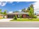 Beautifully landscaped brick home featuring a well-maintained lawn and mature trees at 428 W Valleyview Ave, Littleton, CO 80120