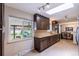 Bright kitchen featuring a skylight, dark wood cabinets, and a window overlooking the backyard at 428 W Valleyview Ave, Littleton, CO 80120