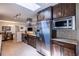 Well-lit kitchen with stainless steel appliances, dark cabinetry, and a skylight at 428 W Valleyview Ave, Littleton, CO 80120