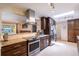 Stylish kitchen with dark wood cabinets, stainless steel appliances, and an open layout at 428 W Valleyview Ave, Littleton, CO 80120