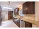 Well-lit kitchen with granite countertops, stainless steel dishwasher, and ample storage space at 428 W Valleyview Ave, Littleton, CO 80120