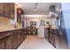 Modern kitchen with stainless steel appliances, granite countertops, and dark wood cabinetry at 428 W Valleyview Ave, Littleton, CO 80120