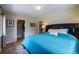 Comfortable bedroom featuring wood floors, large bed, and a walk-in closet at 428 W Valleyview Ave, Littleton, CO 80120