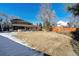 Large backyard with grassy area and home view at 6150 S Fulton St, Englewood, CO 80111