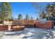 Outdoor entertaining area with firepit, built-in grill, and seating at 6150 S Fulton St, Englewood, CO 80111