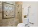 Updated bathroom with a large walk-in shower and tile details at 6150 S Fulton St, Englewood, CO 80111