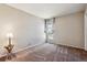 Simple bedroom with neutral carpeting and a large window at 6150 S Fulton St, Englewood, CO 80111