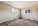 Bright bedroom with neutral decor and two large windows at 6150 S Fulton St, Englewood, CO 80111