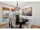 Formal dining room with a chandelier and large windows at 6150 S Fulton St, Englewood, CO 80111