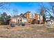 Brick two-story house with landscaping and walkway at 6150 S Fulton St, Englewood, CO 80111