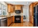 Kitchen with wood cabinets, granite counters, and stainless steel appliances at 6150 S Fulton St, Englewood, CO 80111