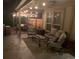 Evening view of patio with seating and string lights at 6150 S Fulton St, Englewood, CO 80111