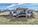 This backyard has an elevated deck with stairs, large windows and a combination of stone and siding at 2730 Fox View Trl, Franktown, CO 80116