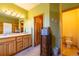 Bright bathroom boasts a double sink vanity and offers access to the toilet and walk-in closet at 6752 S Columbine Rd, Evergreen, CO 80439