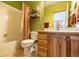 Bathroom featuring wood cabinets, tile flooring and shower over tub at 6752 S Columbine Rd, Evergreen, CO 80439