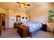Vaulted ceiling bedroom with carpeted floors and a large window with scenic backyard views at 6752 S Columbine Rd, Evergreen, CO 80439
