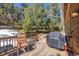 Inviting deck with outdoor seating and grill with a view of the surrounding landscape at 6752 S Columbine Rd, Evergreen, CO 80439