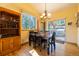 Cozy dining room with wood floors, dining table, built-in cabinet and sliding glass doors to the outside deck at 6752 S Columbine Rd, Evergreen, CO 80439