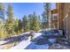 Charming home exterior featuring a swing set and picturesque views of the surrounding trees at 6752 S Columbine Rd, Evergreen, CO 80439