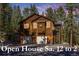 Charming two-story brown home with two-car garage nestled among mature evergreen trees at 6752 S Columbine Rd, Evergreen, CO 80439