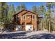 Exterior elevation of the property with an attached garage and staircase at 6752 S Columbine Rd, Evergreen, CO 80439