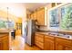Bright kitchen featuring wood cabinets, hardwood floors, and stainless steel refrigerator at 6752 S Columbine Rd, Evergreen, CO 80439