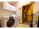 Functional laundry room with washer, dryer, storage cabinets and door to the basement at 6752 S Columbine Rd, Evergreen, CO 80439