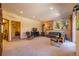 Spacious living room features neutral carpet, wood burning stove, and great natural light at 6752 S Columbine Rd, Evergreen, CO 80439