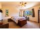 Spacious main bedroom with a vaulted ceiling, ceiling fan, and large windows overlooking trees at 6752 S Columbine Rd, Evergreen, CO 80439