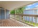 Balcony with wooden deck and white railing offers a view of the surrounding greenery at 8600 E Alameda Ave # 22-208, Denver, CO 80247