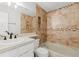 This bathroom has a shower over tub with tiled walls, storage shelves, and vanity with sink at 8600 E Alameda Ave # 22-208, Denver, CO 80247