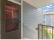 Unit entrance, stairs, with gray wood siding exterior, and a gray storm door at 8600 E Alameda Ave # 22-208, Denver, CO 80247