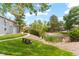 Community with pond, bench, green grass, and mature trees on a sunny day at 8600 E Alameda Ave # 22-208, Denver, CO 80247