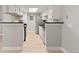 Modern kitchen with white cabinets, stainless steel appliances, and a breakfast bar at 8600 E Alameda Ave # 22-208, Denver, CO 80247