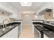 Bright kitchen featuring stainless appliances, black granite countertops, and white cabinets at 8600 E Alameda Ave # 22-208, Denver, CO 80247