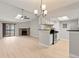 Open floor plan with kitchen, stone fireplace, and dining area with lots of light at 8600 E Alameda Ave # 22-208, Denver, CO 80247