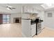 Open floor plan with a stone fireplace and a sliding door to the patio at 8600 E Alameda Ave # 22-208, Denver, CO 80247