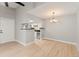 Bright living room with wood floors, chandelier, and an open kitchen area at 8600 E Alameda Ave # 22-208, Denver, CO 80247