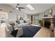 Bright living room features a stone fireplace, ceiling fan, skylight, and sliding glass doors at 8600 E Alameda Ave # 22-208, Denver, CO 80247