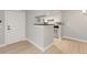 Living room featuring wood floors and open access to the kitchen at 8600 E Alameda Ave # 22-208, Denver, CO 80247