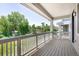 Inviting outdoor balcony with wood floors, railings, and covered ceiling for shade and protection from the elements at 12714 E Dickenson Ave, Aurora, CO 80014