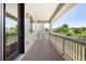 Inviting outdoor balcony with wood floors, railings, and views of the surrounding landscape at 12714 E Dickenson Ave, Aurora, CO 80014