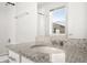 Bathroom with granite counters, undermount sink, chrome hardware, white cabinet, and tub shower combo at 12714 E Dickenson Ave, Aurora, CO 80014